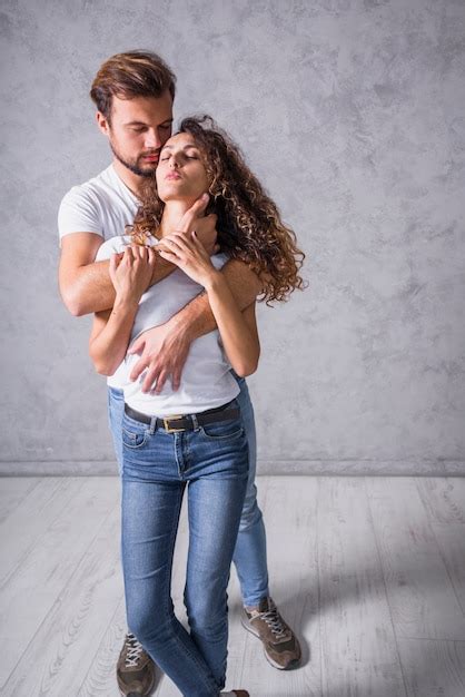 woman hugging man from behind|man holding woman from behind.